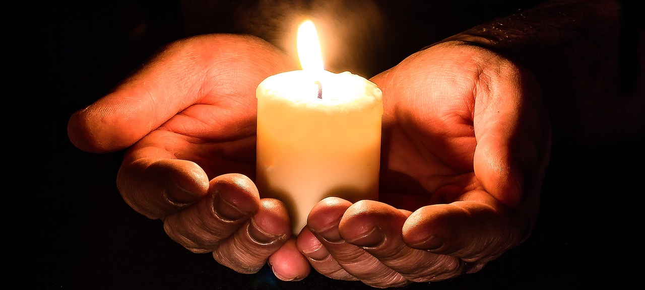 Hope: holding candles in palms: Hope After Egg Donation